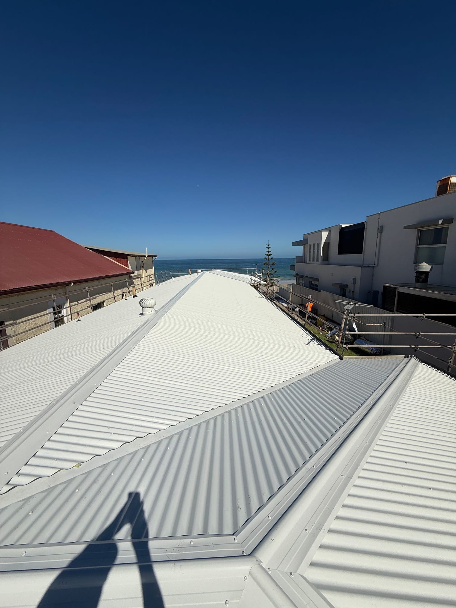 Completed white Colorbond coastal re-roof with ocean view, Henley Beach, Adelaide by Pro Roof and Gutter