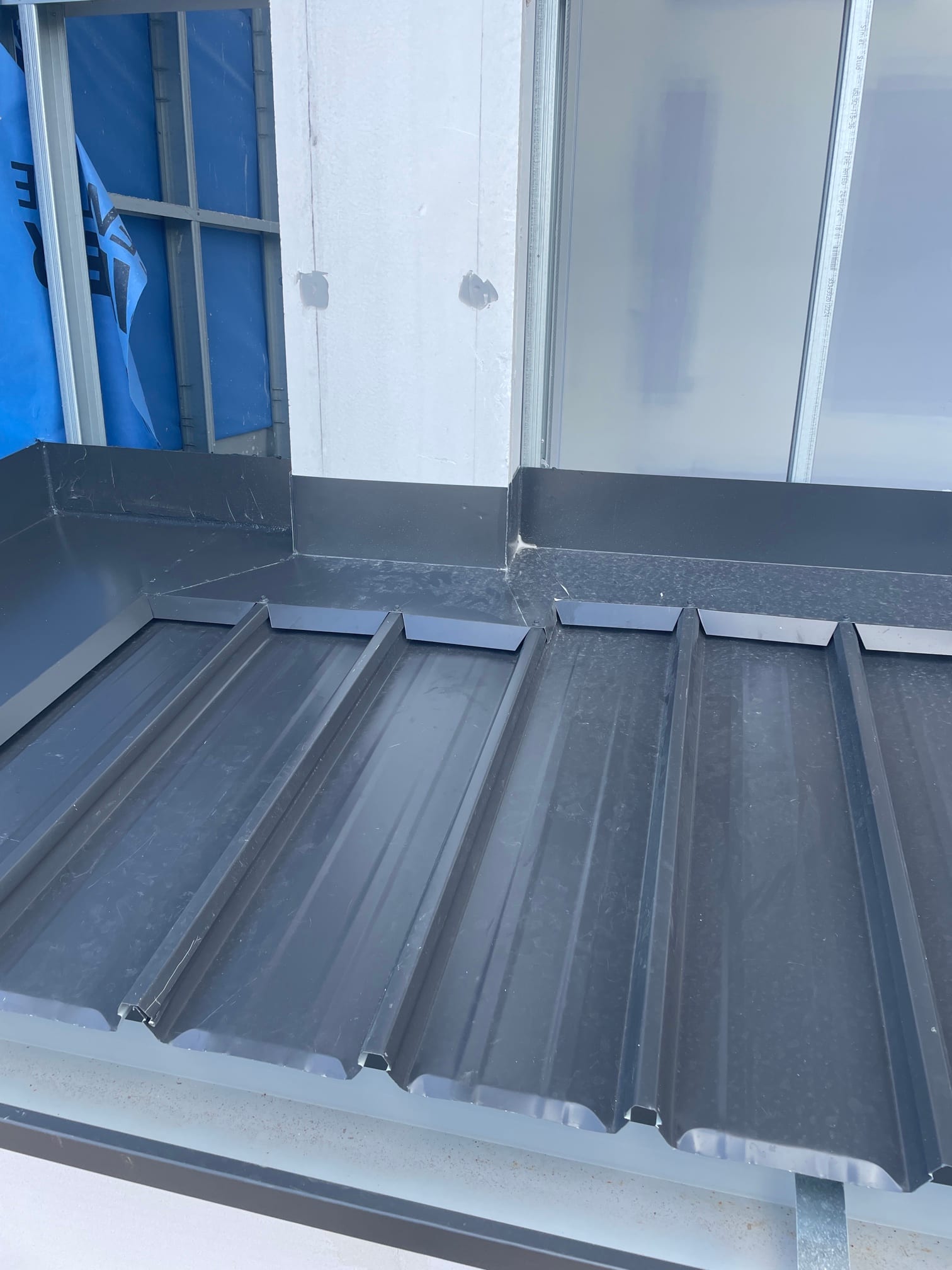 Custom commercial flashing detail around window penetration on a Kliplok concealed-fix roof in Newton, Adelaide