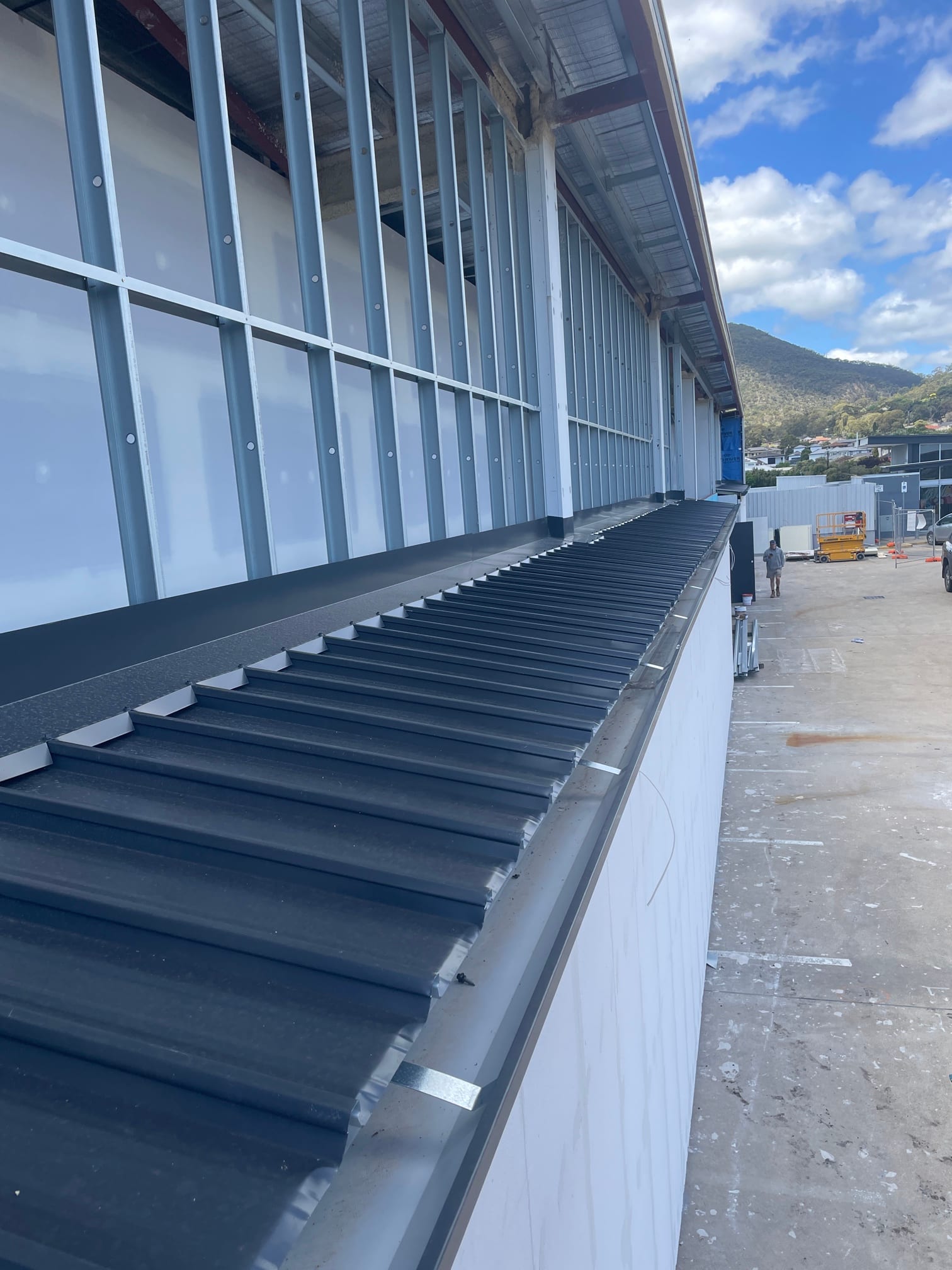 Large 2-storey commercial re-roof in Newton, Adelaide with Adelaide Hills backdrop by Pro Roof and Gutter