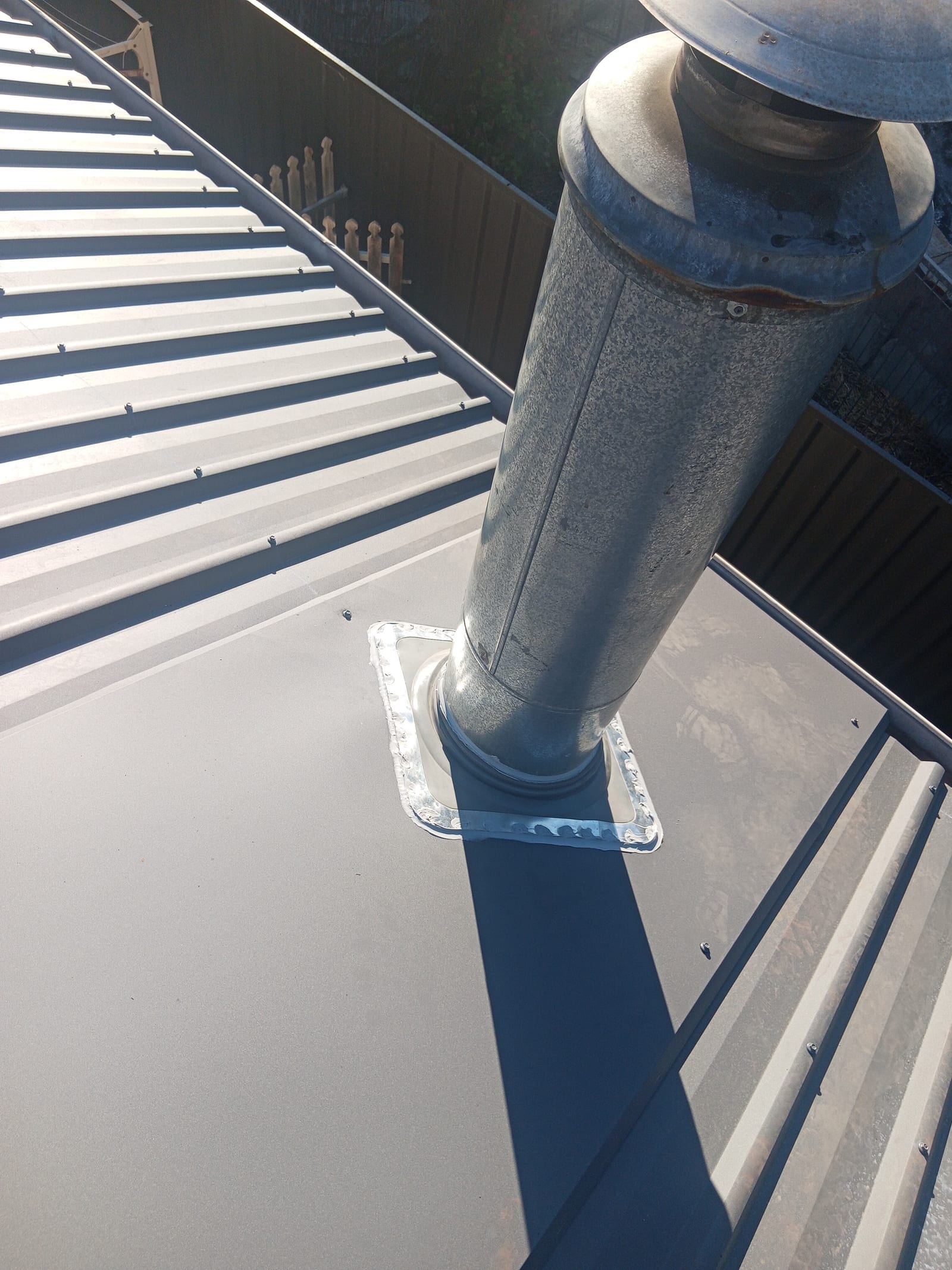 Custom Dektite flashing around a flue penetration on a Colorbond roof in Torrens Park